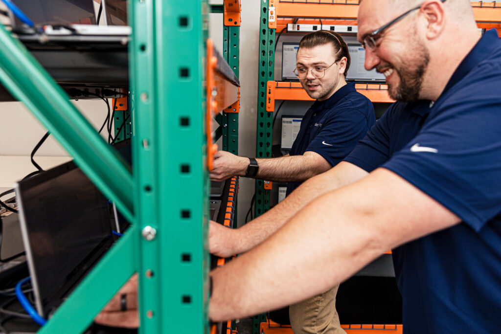 Two men working on client device refresh