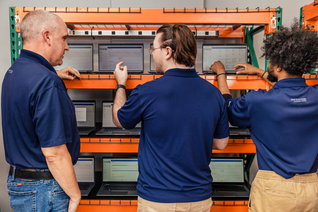 Three men performing a laptop refresh project